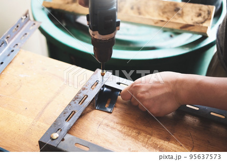 do it yourself concept, Craftsmen use electric drills to assemble old iron parts. Make a shelf on your free weekend. do it yourself concept, Craftsmen use electric drills to assemble old iron parts. Make a shelf on your free weekend. 95637573