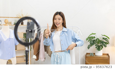 Beautiful woman with a social media influence is greeting the audience for recording vlog video live streaming, Online fashion clothing business, Using psychology to generate interest in customers. 95637623