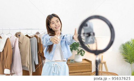 Beautiful woman with a social media influence is greeting the audience for recording vlog video live streaming, Online fashion clothing business, Using psychology to generate interest in customers. Beautiful woman with a social media influence is greeting the audience for recording vlog video live streaming, Online fashion clothing business, Using psychology to generate interest in customers. 95637625