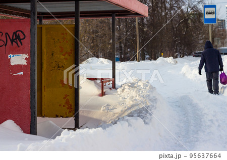 An old metal bus stop from the times of the USSR littered with snow in a Russian city An old metal bus stop from the times of the USSR littered with snow in a Russian city 95637664