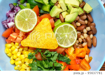 Salad texas caviar close up. Vegetable dish with corn, beans, pepper, pepper, tomatoes, beans. Served with corn chips nachos Salad texas caviar close up. Vegetable dish with corn, beans, pepper, pepper, tomatoes, beans. Served with corn chips nachos 95637781