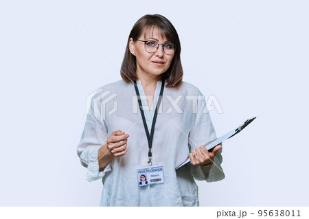 Female medical center worker with clipboard badge on white background Female medical center worker with clipboard badge on white background 95638011