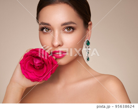 Beautiful young woman a rose flower Beautiful young woman a rose flower 95638624