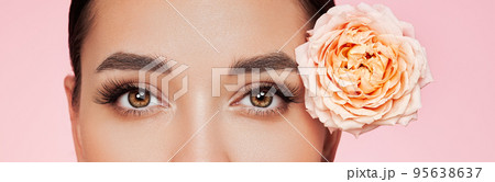 Beautiful young woman with a rose flower Beautiful young woman with a rose flower 95638637