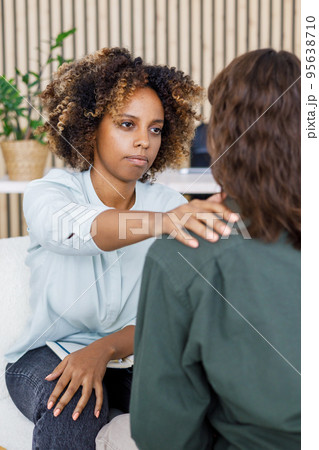 African American female psychologist conducts an appointment with a patient in the office. mental health and moral support. African American female psychologist conducts an appointment with a patient in the office. mental health and moral support. 95638710