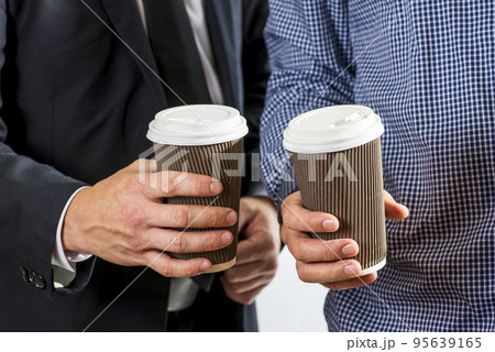 Diverse coworkers with drinks to go in paper cups drinking coffee together 95639165