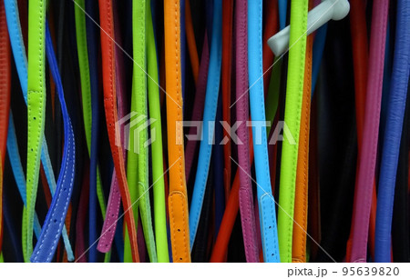 Colored leather straps belts on the showcase at fashion accessories shop Colored leather straps belts on the showcase at fashion accessories shop 95639820