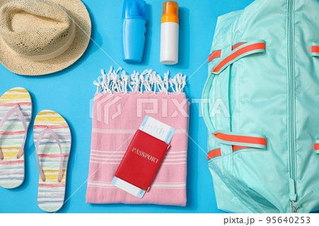 Flat lay composition with bag and travel accessories on blue background 95640253