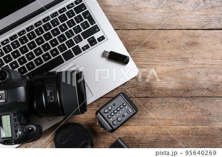 Flat lay composition with equipment for professional photographer on wooden table 95640269