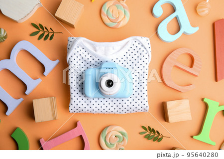 Flat lay composition with toy camera on orange background. Future photographer Flat lay composition with toy camera on orange background. Future photographer 95640280