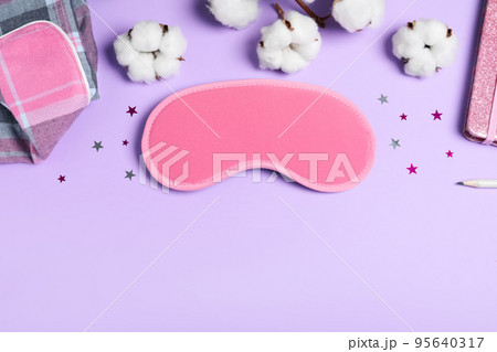 Flat lay composition with sleeping mask on violet background, space for text. Bedtime accessory Flat lay composition with sleeping mask on violet background, space for text. Bedtime accessory 95640317
