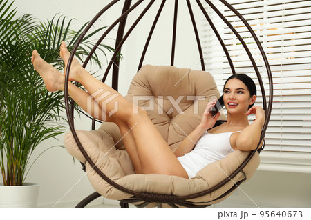 Beautiful young woman in white underwear talking on phone at home Beautiful young woman in white underwear talking on phone at home 95640673