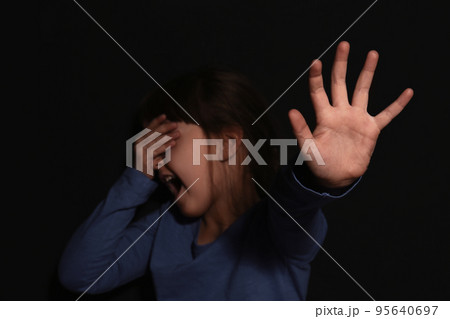 Abused little girl showing with phrase HELP ME near blue wall, focus on hand. Abused little girl showing with phrase HELP ME near blue wall, focus on hand. 95640697