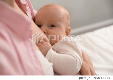Young woman breast feeding her little baby, closeup Young woman breast feeding her little baby, closeup 95641115
