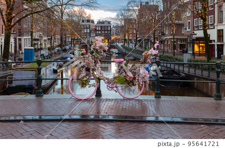 Beautiful old houses on the city waterfront of Amsterdam at sunset. 95641721