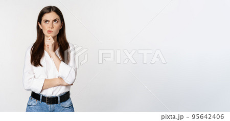 Portrait of female entrepreneur thinking, making choice, standing thoughtful, white studio background Portrait of female entrepreneur thinking, making choice, standing thoughtful, white studio background 95642406