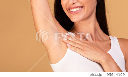 Hair removal concept. Unrecognizable lady demonstrating her armpit with smooth skin and smiling, copy space Hair removal concept. Unrecognizable lady demonstrating her armpit with smooth skin and smiling, copy space 95644109