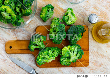 Sliced fresh broccoli on kitchen board. Cooking concept 95644833