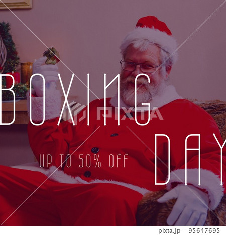 Square image of santa claus holding gift and boxing day up to 50 percent text 95647695