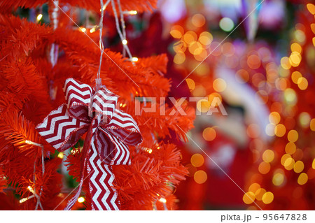 Ribbon display at red Christmas tree. 95647828