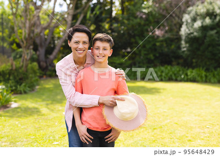 Caucasian mother and son spending time together in the garden 95648429