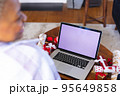 Happy african american woman using laptop with copy space 95649858