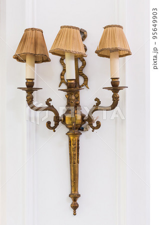 Ancient bronze candle holders are used for decoration 95649903