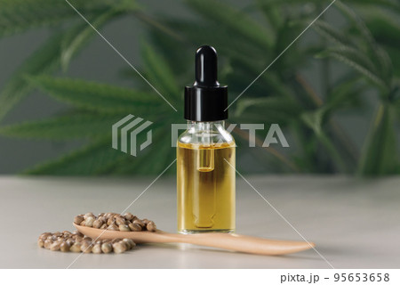Legalized CBD oil extracted from marijuana in a glass bottle with a dropper lid. 95653658