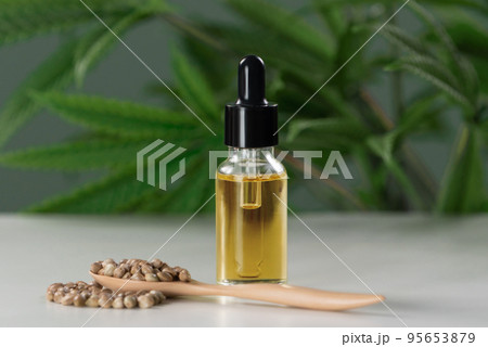 Legalized CBD oil extracted from marijuana in a glass bottle with a dropper lid. Legalized CBD oil extracted from marijuana in a glass bottle with a dropper lid. 95653879