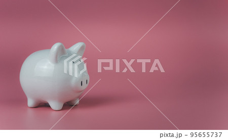 white piggy bank on a pink background. Savings and investment concepts. white piggy bank on a pink background. Savings and investment concepts. 95655737