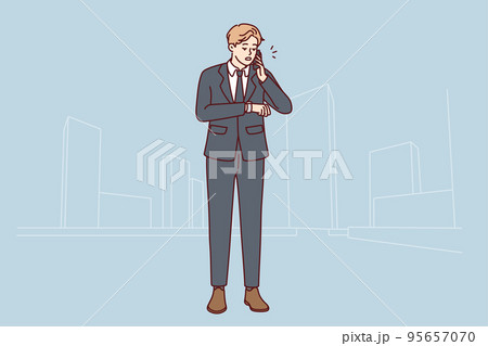 Businessman talk on cellphone check time on clock 95657070