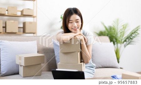 Small business owners or SMEs doing business related to selling and shipping online, New business style for young people working at home and owning businesses, Packing box, Sell online concept. Small business owners or SMEs doing business related to selling and shipping online, New business style for young people working at home and owning businesses, Packing box, Sell online concept. 95657883