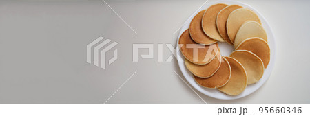 Round plate with freshly baked tasty pancakes, hot delicious meal for breakfast, nutritious snack 95660346