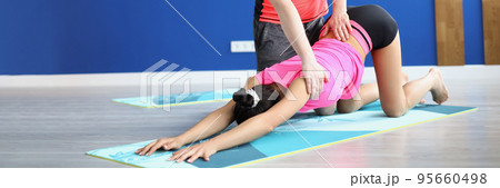 Man partner support woman in stretching on mat, yoga class for health Man partner support woman in stretching on mat, yoga class for health 95660498