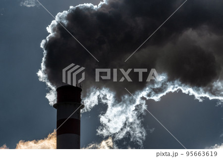 Dark smoke from smokestack against the sky 95663619