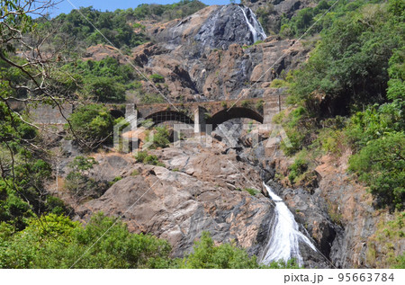 Dudhsagar Waterfalls a four-tiered waterfall located on the Mandovi River, Goa, India Dudhsagar Waterfalls a four-tiered waterfall located on the Mandovi River, Goa, India 95663784