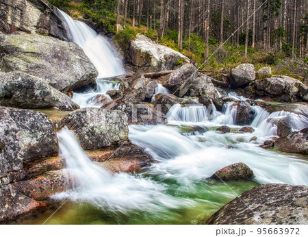 Water flowing at waterfall called Vodopady Studeneho potoka in High Tatras mountains in Sovakia 95663972