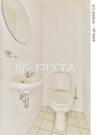 Sink and mirror located near flush toilet Sink and mirror located near flush toilet 95668718