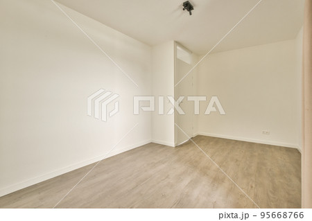 Interior of empty modern apartment with white walls and parquet floor illuminated with lamp Interior of empty modern apartment with white walls and parquet floor illuminated with lamp 95668766
