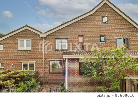 Panorama view of brick houses from an empty sidewalk street with cars, trees Panorama view of brick houses from an empty sidewalk street with cars, trees 95669010