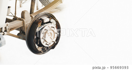 Inside system of the car drum brake, car without a wheel for brake inspection in auto repair garage Inside system of the car drum brake, car without a wheel for brake inspection in auto repair garage 95669393