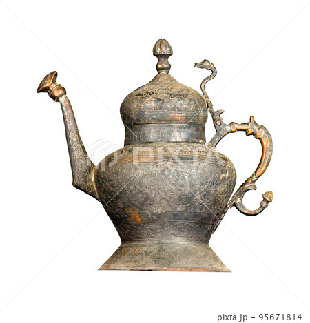 An antique metal teapot with artistic chasing and engraving on a white background 95671814