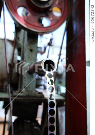 Perforated metal tape. Production of bearings. Equipment at the factory for production of bearings. Photos without people.Vertical photo.Selective focus. Perforated metal tape. Production of bearings. Equipment at the factory for production of bearings. Photos without people.Vertical photo.Selective focus. 95672242