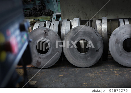 Blanks for large diameter bearings. Metal products. Heavy industry.The control panel with the red button on the production is out of focus.The concept of the industrial industry. Blanks for large diameter bearings. Metal products. Heavy industry.The control panel with the red button on the production is out of focus.The concept of the industrial industry. 95672276