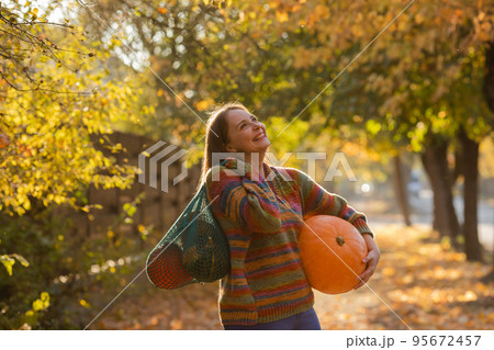 Portrait of happy smile woman with pumpkins in hand. 95672457