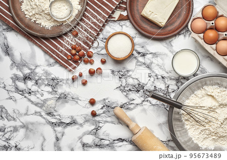Close-up shot. Top view of a baking ingredients and kitchenware on the marble table background. 95673489