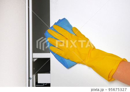 Household chores. Hand using a rag is cleaning furniture at home. Maid cleans house. Household chores. Hand using a rag is cleaning furniture at home. Maid cleans house. 95675327