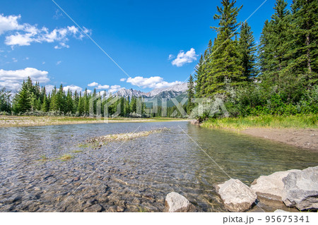 A beautiful photo of river in Canmore, Alberta with the rocky mountains in the background. A beautiful photo of river in Canmore, Alberta with the rocky mountains in the background. 95675341