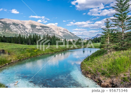 A beautiful photo of river in Canmore, Alberta with the rocky mountains in the background.  95675346
