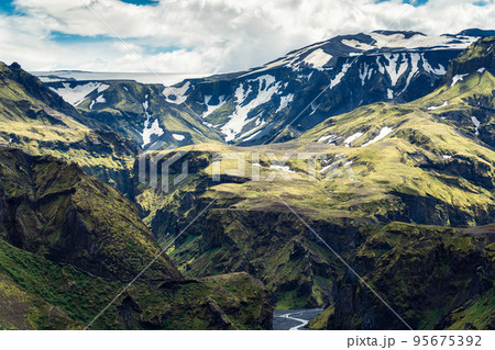 Green mountain canyon with snow covered and river in Icelandic Highlands Green mountain canyon with snow covered and river in Icelandic Highlands 95675392